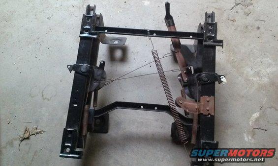 Seat frame assembly with springs and levers. Shows some rust