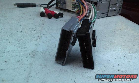 Car stereo wiring harness with RCA connectors and a power adapter