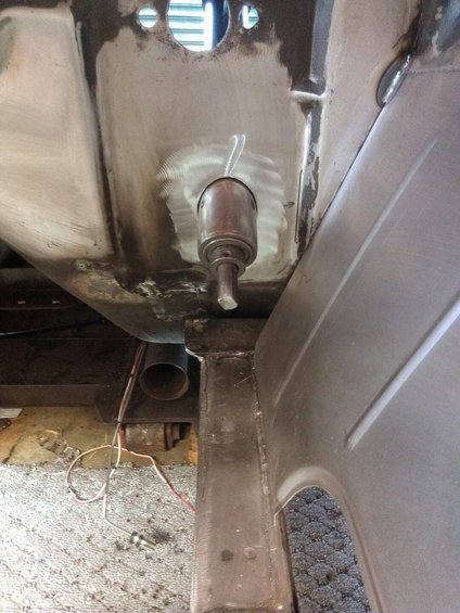 Underbody part with a metal cylinder and rod, viewed from below