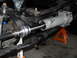 1992 Ford Bronco - This image shows a close-up view of a power steering cylinder installation on a vehicle's steering system.