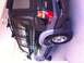 1997 Toyota Land Cruiser - The rear quarter panel and taillight assembly of a dark gray SUV are visible.