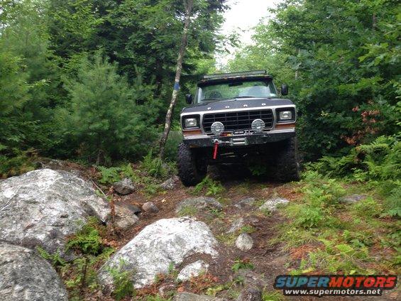 Black 1979 Ford Bronco navigating rocky terrain