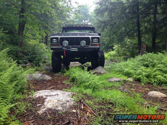 Black 1979 Ford Bronco with winch on rocky forest trail