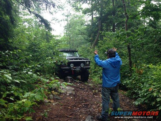 Black 1978 Ford Bronco off-roading, front view with winch and auxiliary lights