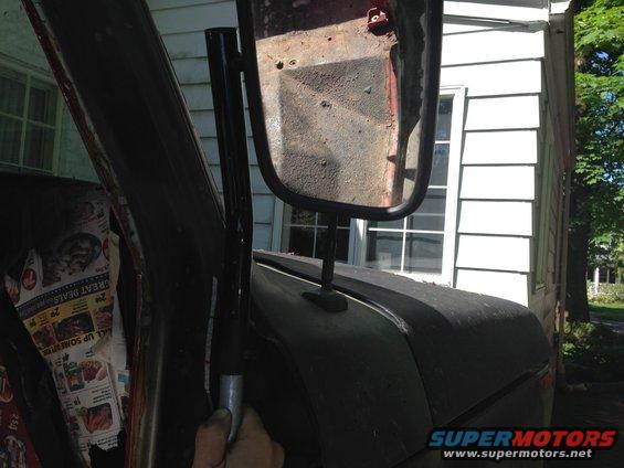 Side mirror assembly and interior door panel with newspaper lining