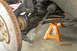 1985 Volkswagen GTI - Car's front suspension components, including brake rotor and tie rod, are visible with the vehicle on a jack stand.
