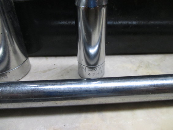 Close-up of socket wrench extensions and a socket with markings 'EN=VV' and '4333'