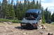 1983 Ford Bronco - This Ford Bronco is navigating a rocky obstacle on an off-road trail, with another vehicle in the distance.