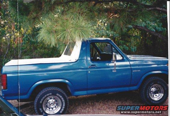 Blue 1982 Ford Bronco side view with white removable top