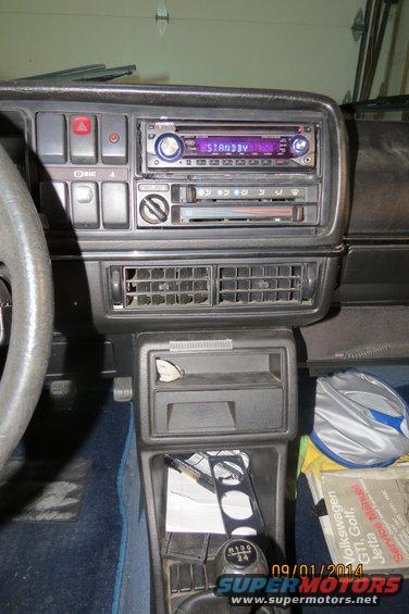 1985 Volkswagen GTI interior showing dashboard, radio, vents, and gear shift