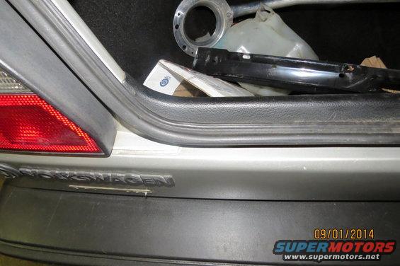 Rear bumper with VOLKSWAGEN badging and trunk interior. Likely a Mk2 Golf/Jetta