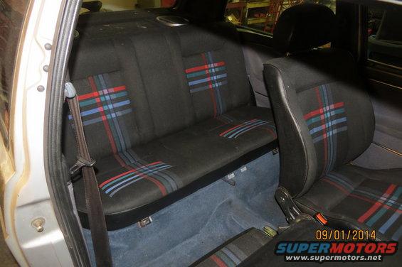 Car interior with plaid seats and seatbelts. Date stamp shows 09/01/2014