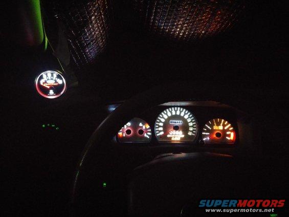 2000 Mercury Grand Marquis interior with illuminated dashboard gauges and a tachometer