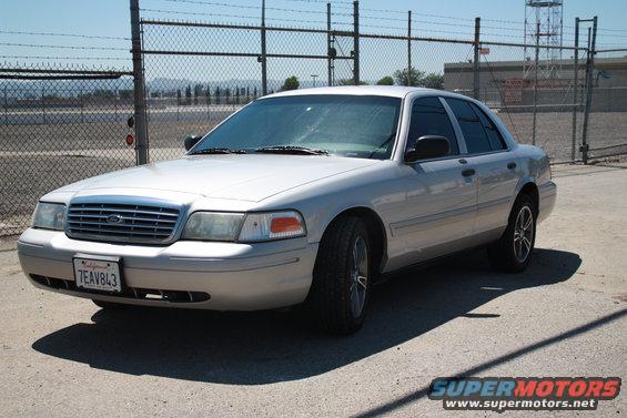 Silver 2004 Ford Crown Victoria parked outdoors, front quarter view. License plate 7EAV843