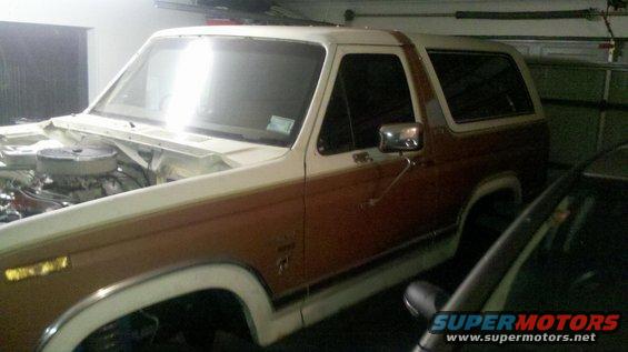 Engine bay of a 1982 Ford Bronco, two-tone brown and white