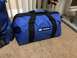 1997 Dodge 3500 - A blue duffel bag with a Macs logo is placed on a carpeted floor.