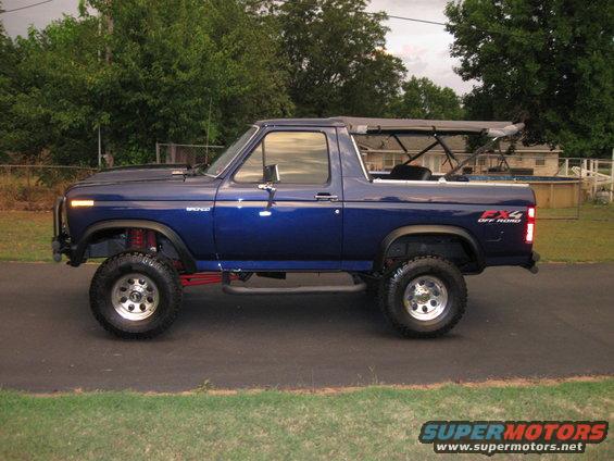 Blue 1982 Ford Bronco side view with soft top removed