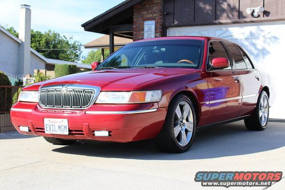 2002 Mercury Grand Marquis parked in driveway, California license plate reads EVIL MGM