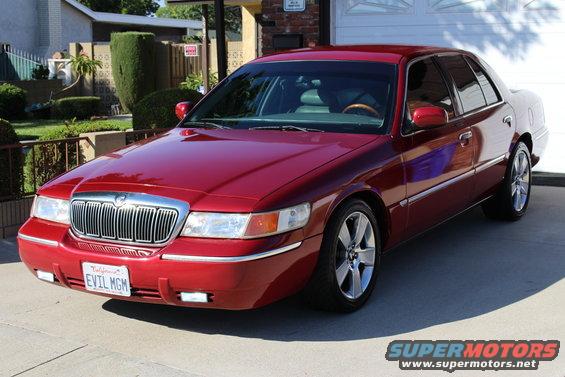 Red 2002 Mercury Grand Marquis parked in a driveway