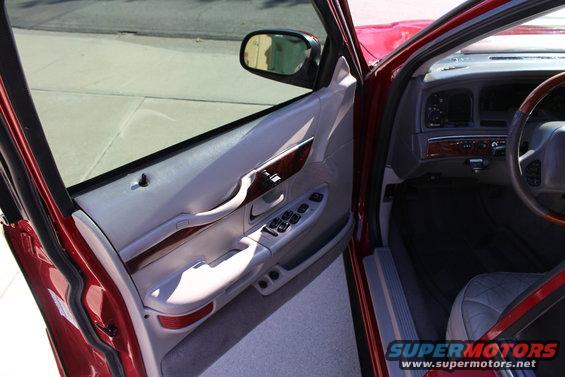 2002 Mercury Grand Marquis interior showing driver's door panel, dashboard, and steering wheel