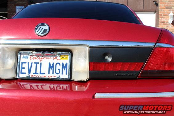 Rear of a red 2002 Mercury Grand Marquis with a California license plate that says EVIL MGM