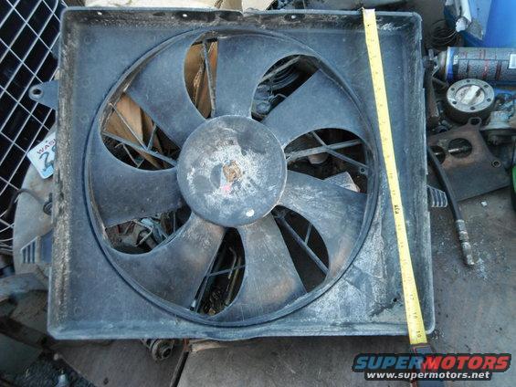 Radiator fan with a yellow measuring tape next to it. A "WASHINGTON 2" sticker is visible on the left
