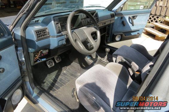 1990 Volkswagen Jetta interior showing dashboard, steering wheel, seats, and gear shifter