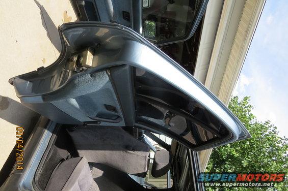 Car interior with open doors, showing grey upholstery and door panels