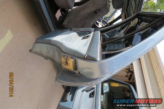 Car door open, showing interior door panel, seat, and steering wheel. Watermark 'SUPERMOTORS.NET' visible