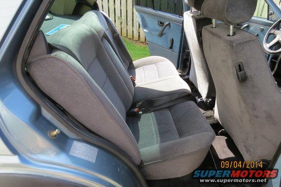Blue 1990 Volkswagen Jetta interior with grey fabric seats and door panels, viewed from the rear passenger side