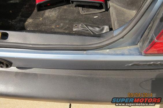 Car's rear bumper and trunk opening with carpeted floor. Date stamp 09/04/2014