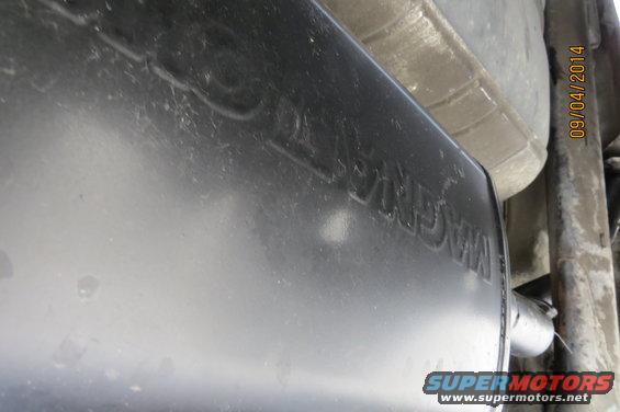 Exhaust muffler with 'MAGNAFLOW' embossed, viewed from below