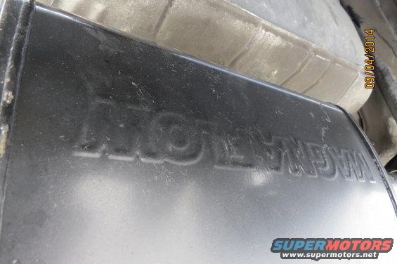 Exhaust muffler with embossed WAGNER text