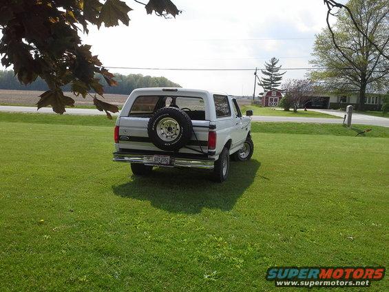 White 1996 Ford Bronco rear view with spare tire mounted on the tailgate