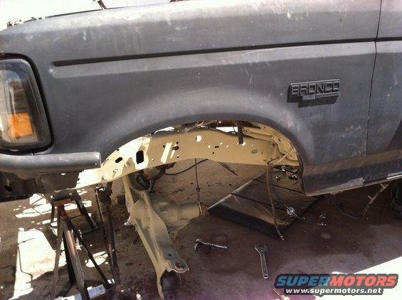 Front fender and suspension of a 1995 Ford Bronco, appears to be undergoing repairs
