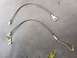 1979 Ford Bronco - Pair of braided stainless steel brake hoses with metal fittings on a dark surface.