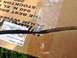 1979 Ford Bronco - A close-up of a dipstick lies on a cardboard box with shipping information visible.
