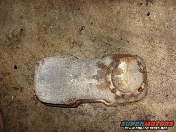 Rusty muffler part on concrete floor