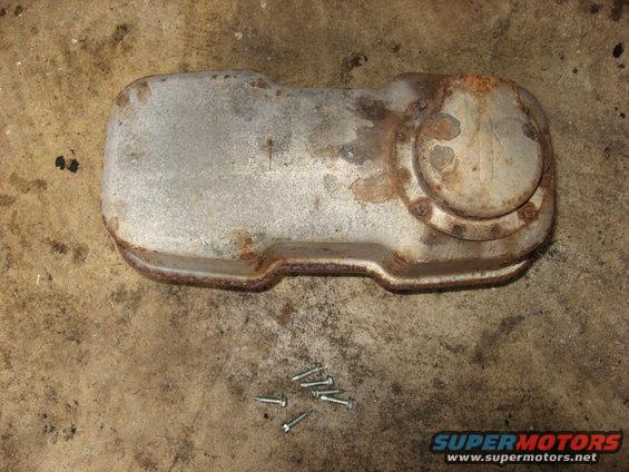 Rusted muffler part with screws on concrete