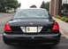 2009 Ford Crown Victoria - Rear view of a black 2009 Ford Crown Victoria, identified by its body style and bearing a State Patrol license plate.