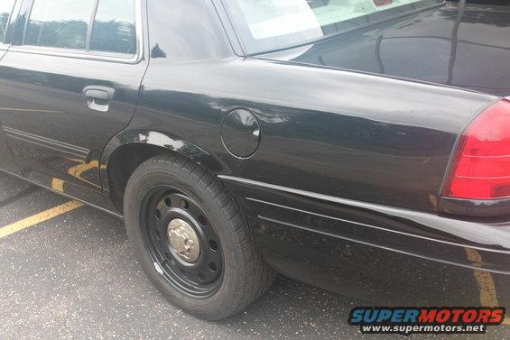 2009 Ford Crown Victoria side view, black paint, steel wheels