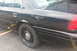 2009 Ford Crown Victoria - Side view of a black 2009 Ford Crown Victoria with steel wheels.