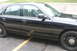 2009 Ford Crown Victoria - Side profile of a black 2009 Ford Crown Victoria sedan parked on asphalt.