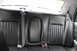 2009 Ford Crown Victoria - The interior rear seat of a vehicle, showing black leather seats and seatbelts.