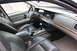 2009 Ford Crown Victoria - The interior of a 2009 Ford Crown Victoria is visible, with dark leather seats and wood trim on the dashboard.