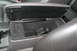 2009 Ford Crown Victoria - Interior view of a car's center console and armrest, showing storage compartment.