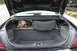 2009 Ford Crown Victoria - The trunk of a car contains a spare tire, wiring, and custom storage compartments.