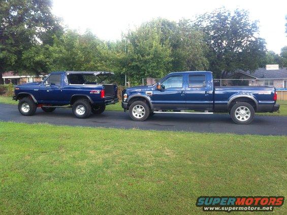Blue 1980s Ford Bronco with removable top next to a blue Ford F-Series truck