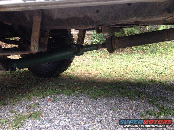 Undercarriage view of truck driveshaft and tire
