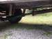 1971 Ford F-250 - A view of the undercarriage reveals the driveshaft and a tire, with the frame of the vehicle visible above.